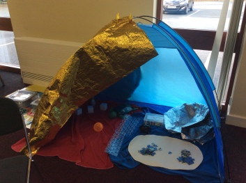 A small tent with sensory toys inside